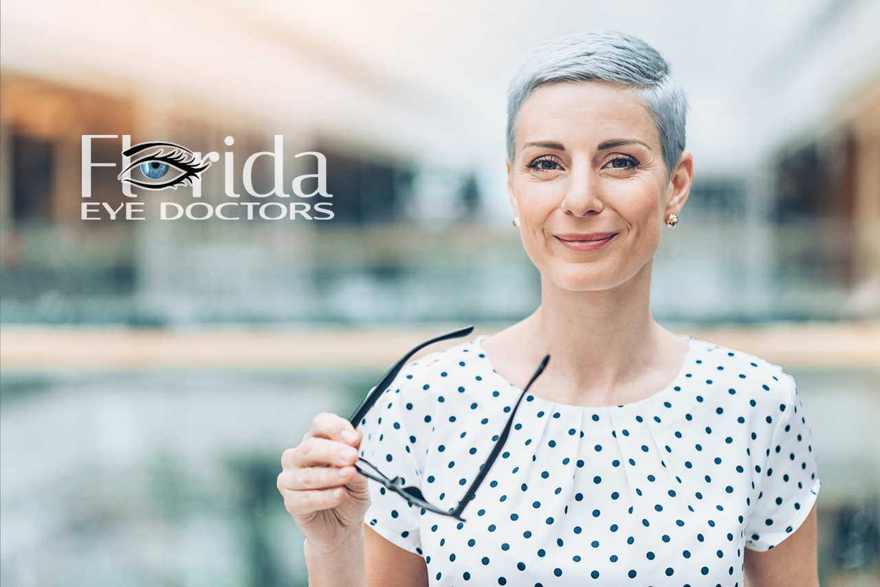 patient holding up a pair of perscription glasses